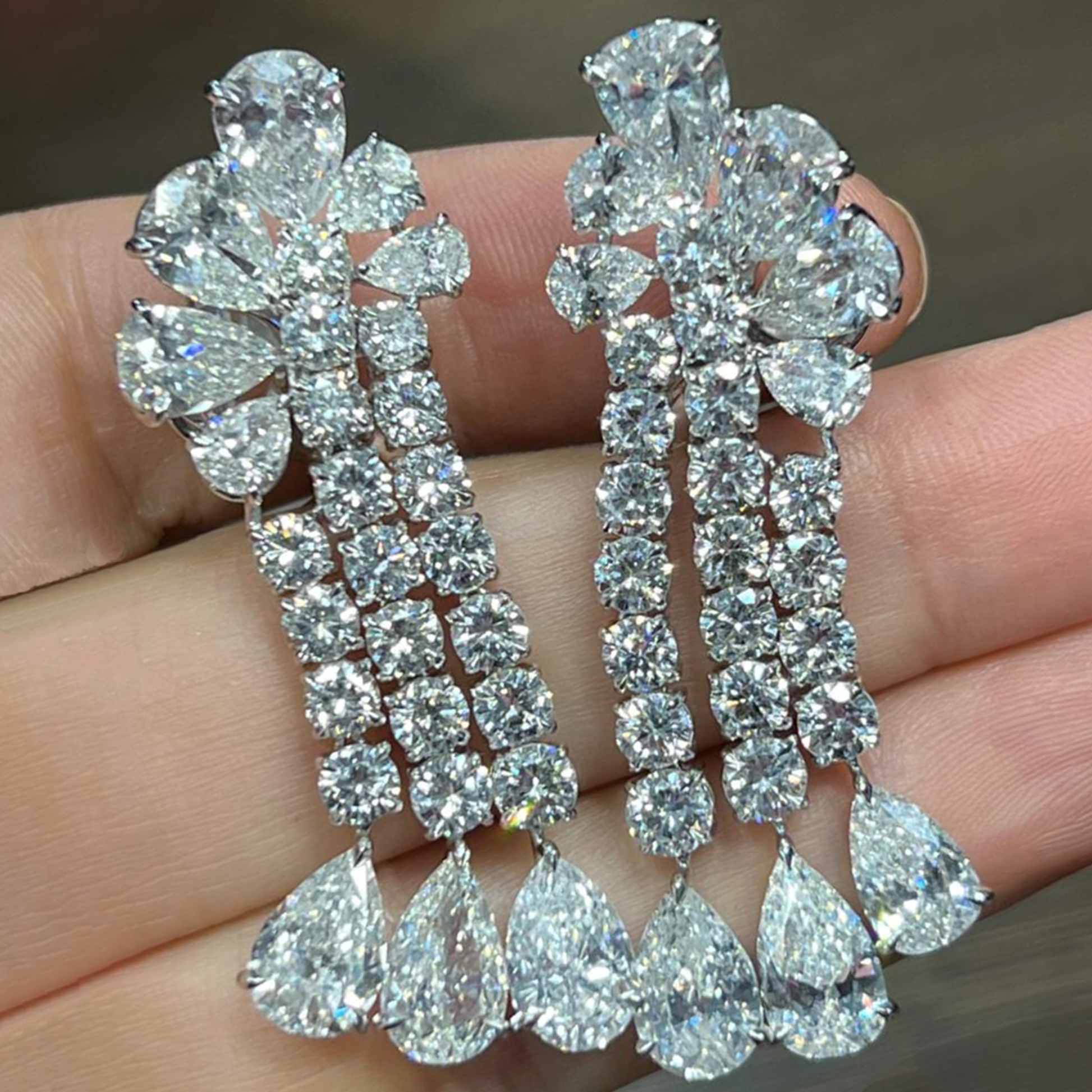 Post-1980s Platinum Diamond Earrings in hand