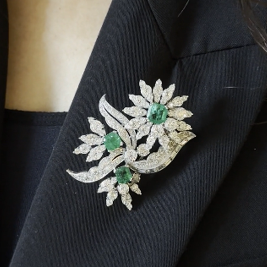 1960s Platinum Diamond & Emerald Flower Brooch worn on blazer