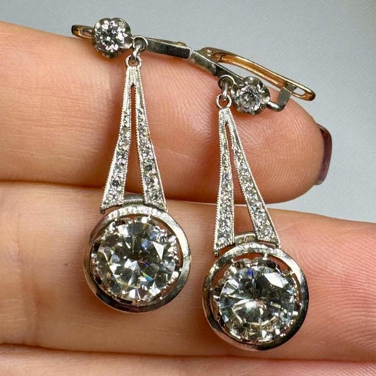 Art Deco Platinum Diamond Earrings in hand