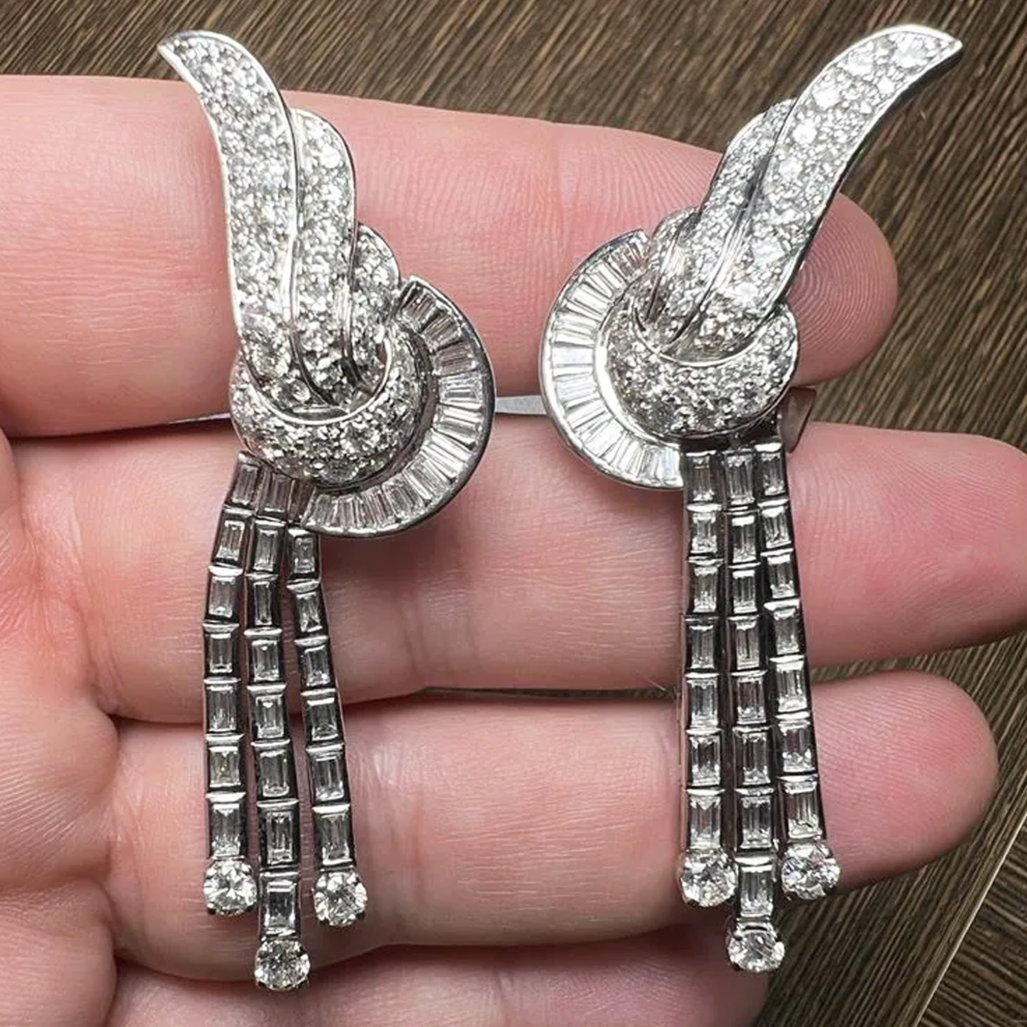 1950s Platinum Diamond Earrings in hand