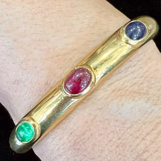 David Webb Post-1980s 18KT Yellow Gold Ruby, Emerald & Blue Sapphire Bangle Bracelet worn on wrist