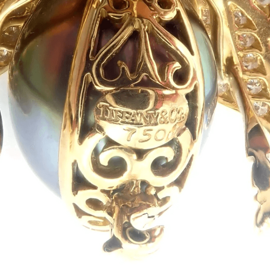 Tiffany & Co. 1980s 18KT Yellow Gold Diamond, Emerald, Tanzanite & Pearl Fly Brooch signature