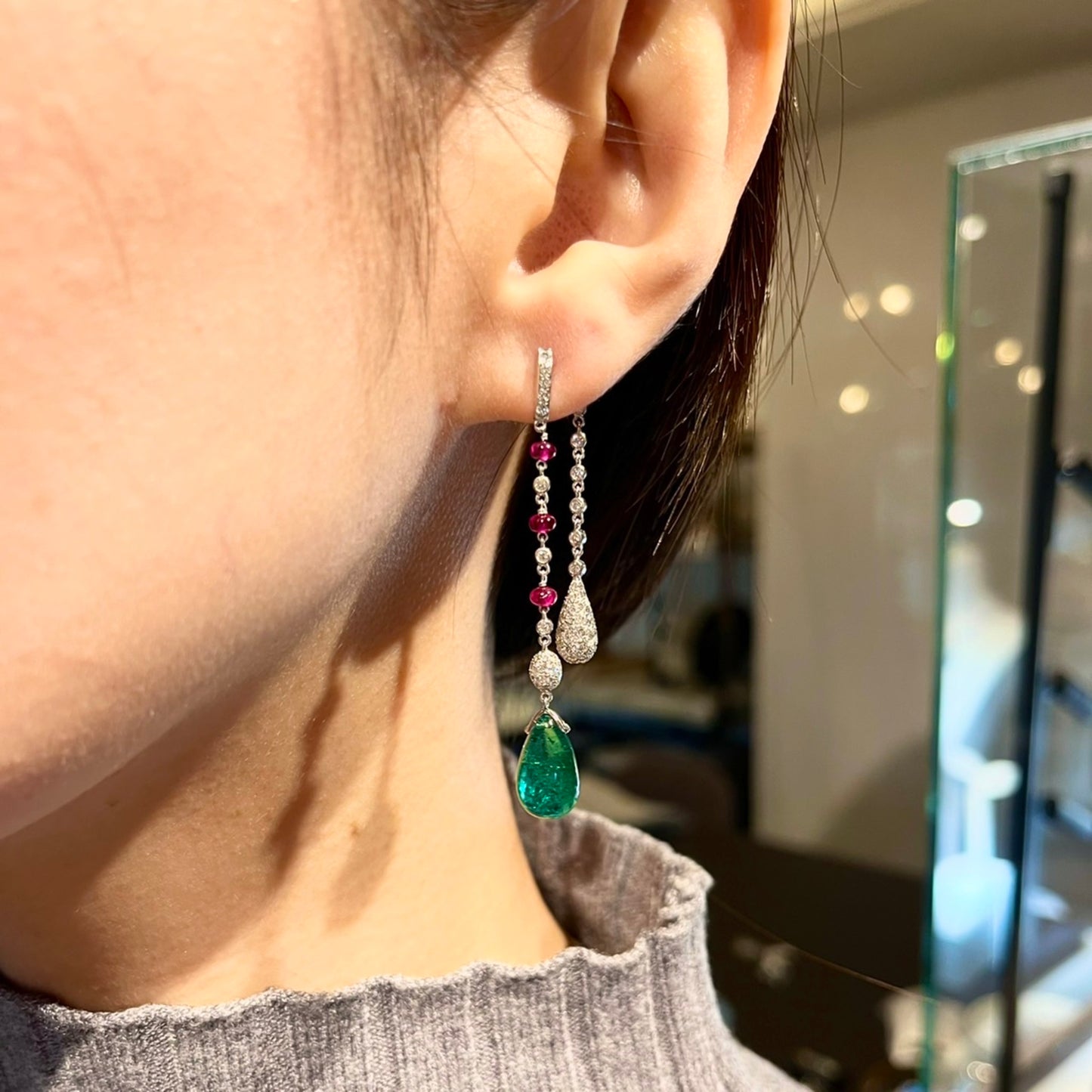 Contemporary 18KT White Gold Emerald, Diamond & Ruby Earrings on ear