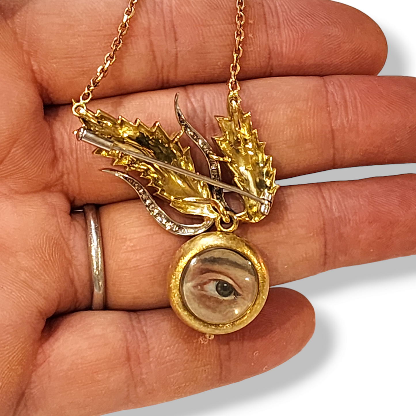 1970s 18KT Yellow Gold Diamond Lover's Eye Locket Brooch in hand