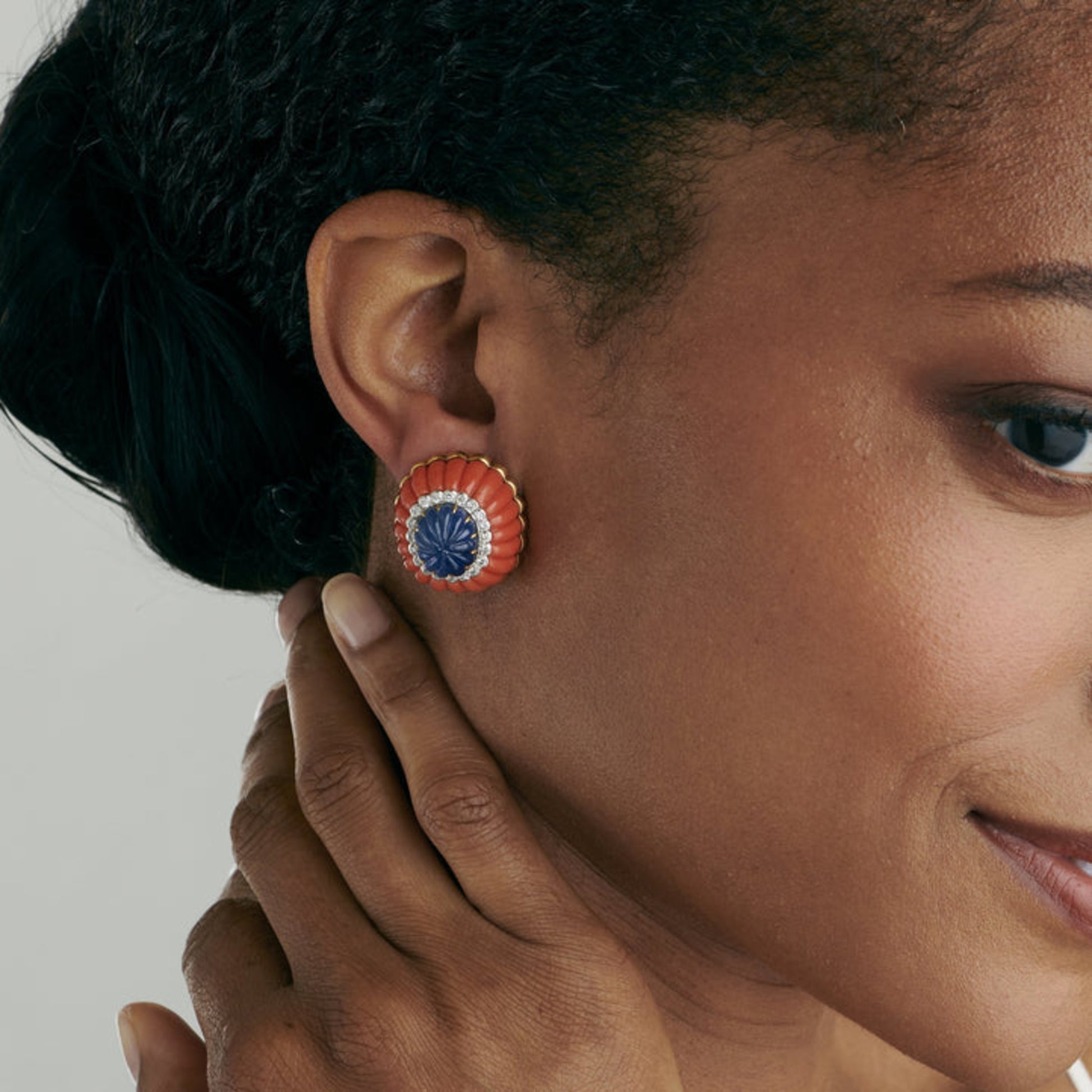 David Webb Post-1980s Platinum & 18KT Yellow Gold Sapphire, Coral & Diamond Earrings on ear