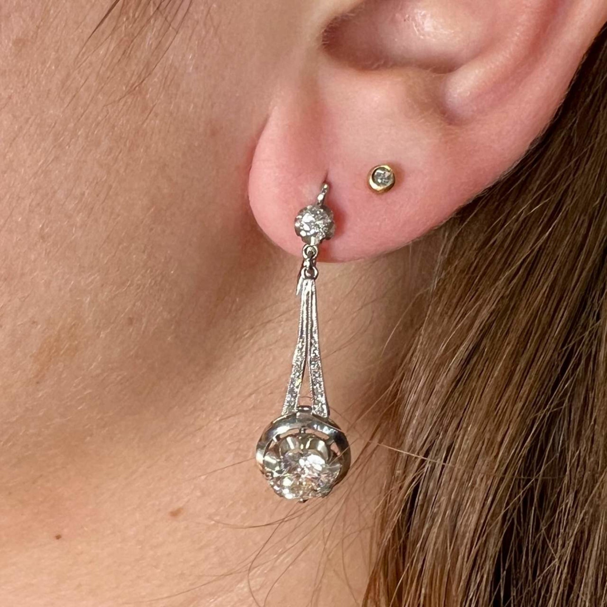 Art Deco Platinum & 18KT Yellow Gold Diamond Earrings on ear