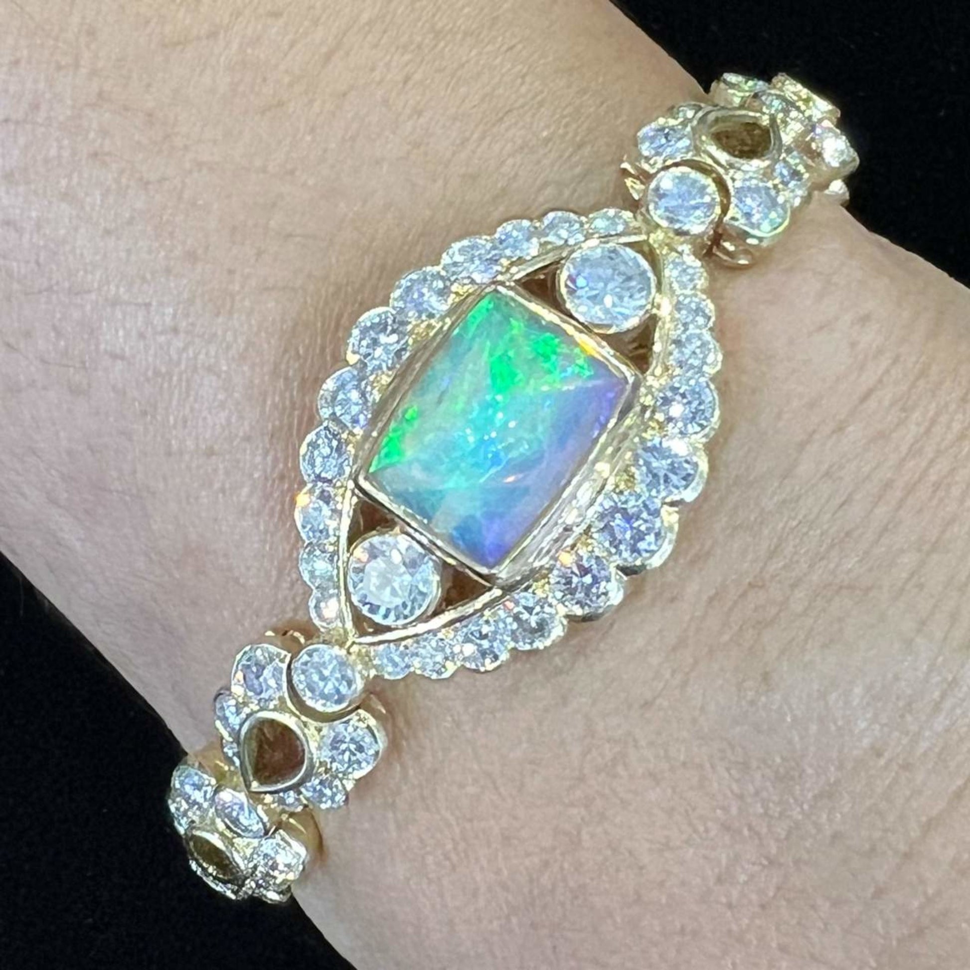 1980s 18KT Yellow Gold Opal & Diamond Bracelet on wrist