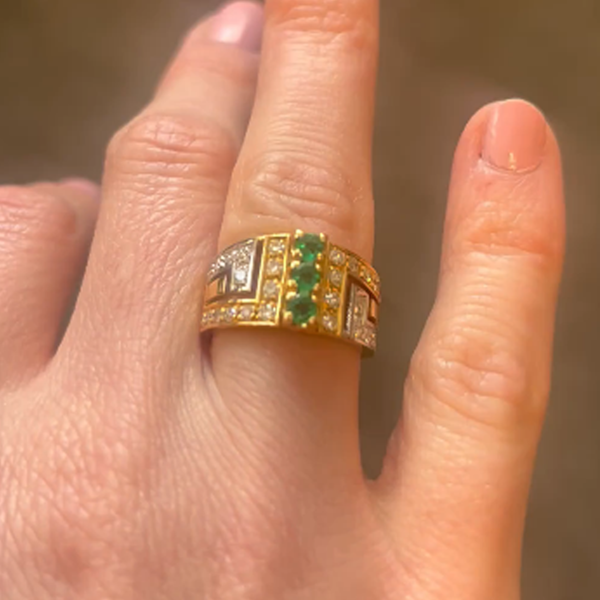 1980s 18KT Yellow Gold Diamond & Emerald Ring on finger