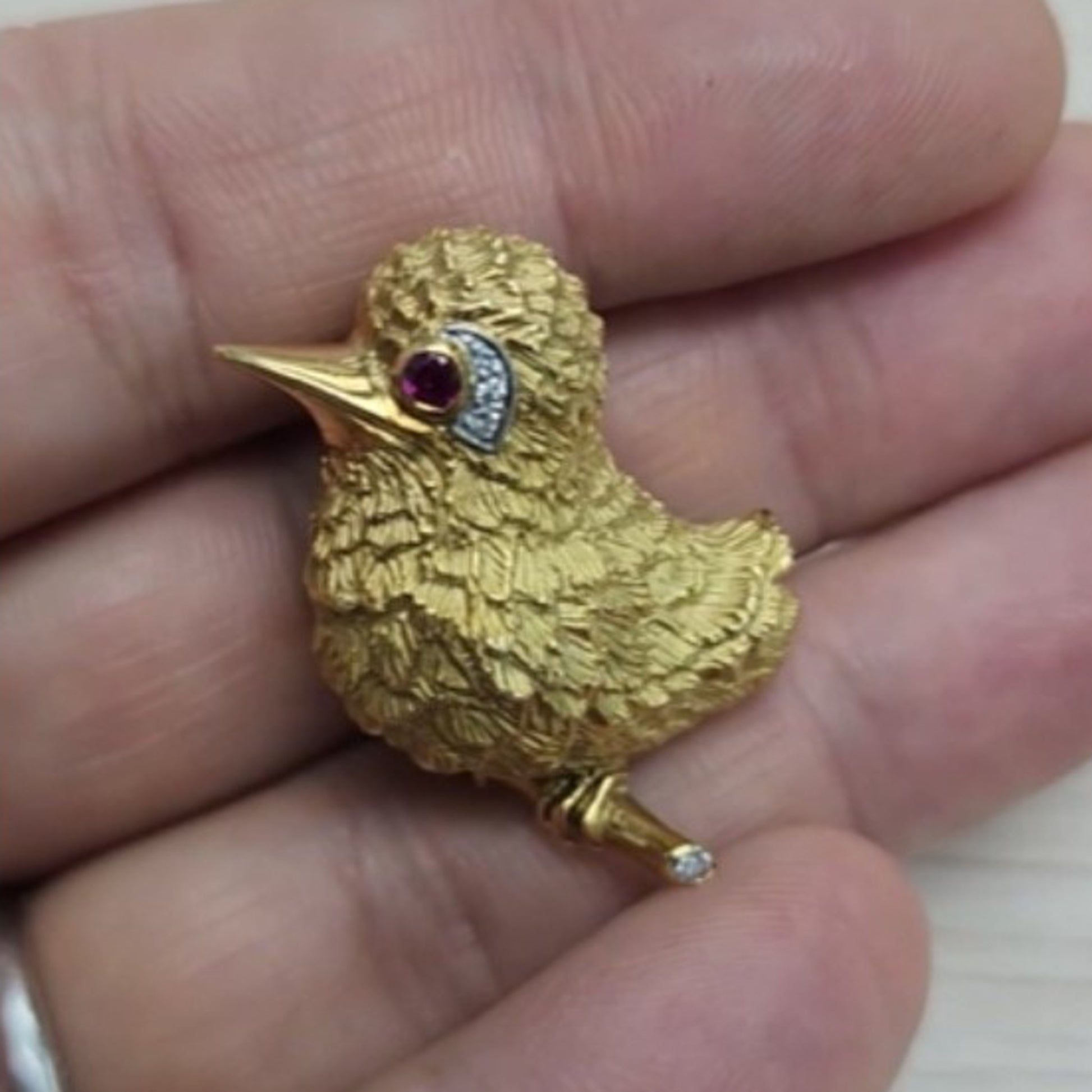 Cartier 1960s 18KT Yellow Gold Ruby & Diamond Bird Brooch in hand