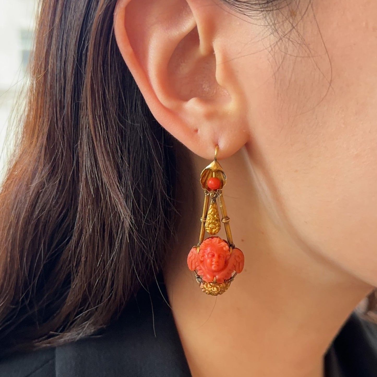 Victorian 18KT Yellow Gold Coral Cherub Earrings on ear