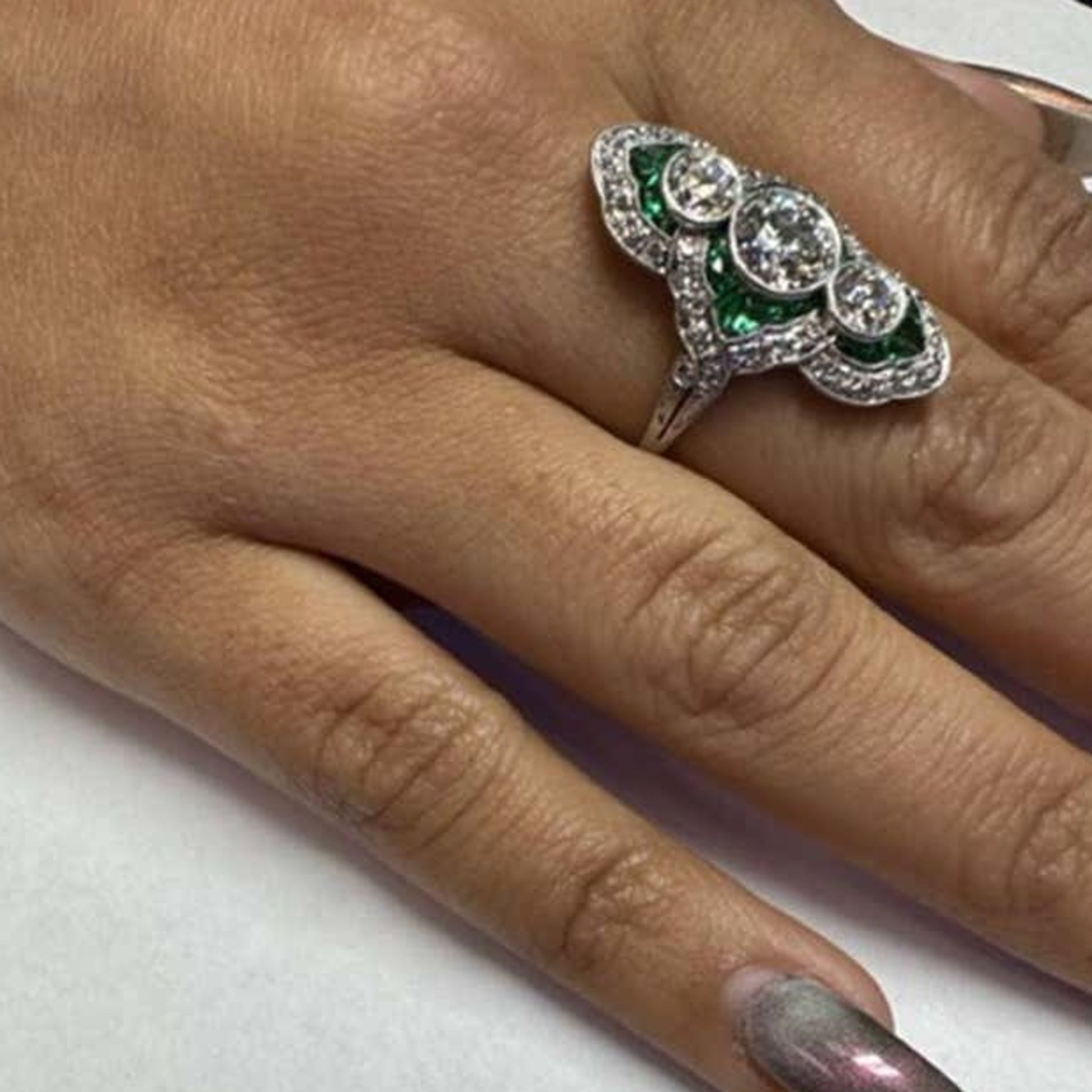 Art Deco Platinum Diamond & Emerald Ring on finger