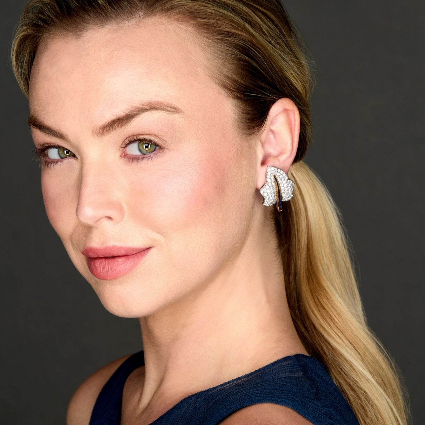 Oscar Heyman Bros 1980s Platinum & 18KT Yellow Gold Diamond & Sapphire Leaf Earrings on ear