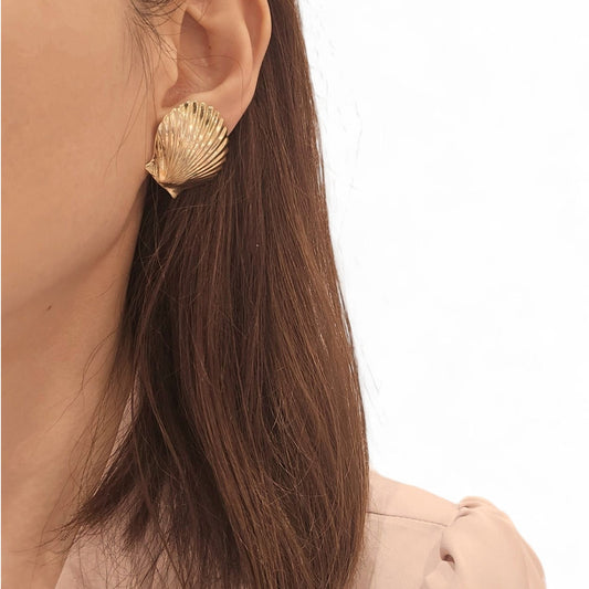 Cartier 1960s 14KT Yellow Gold Shell Earrings on ear