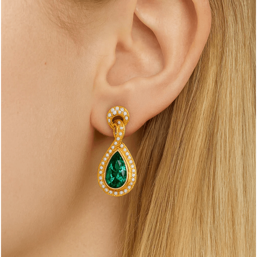 Contemporary 18KT Yellow Gold Emerald & Diamond Earrings on ear