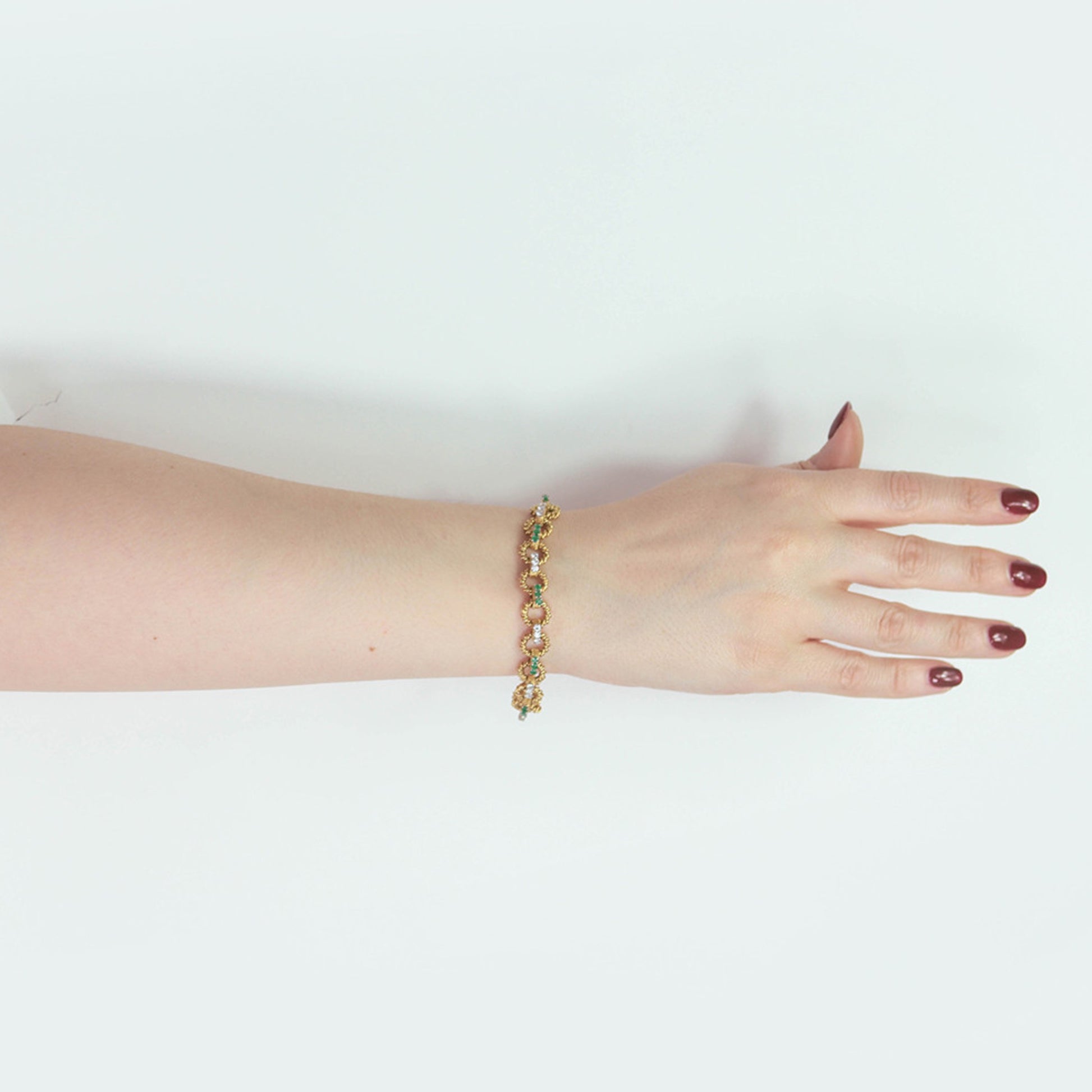 Boucheron Paris 1970s Platinum & 18KT Yellow Gold Emerald & Diamond Bracelet on wrist