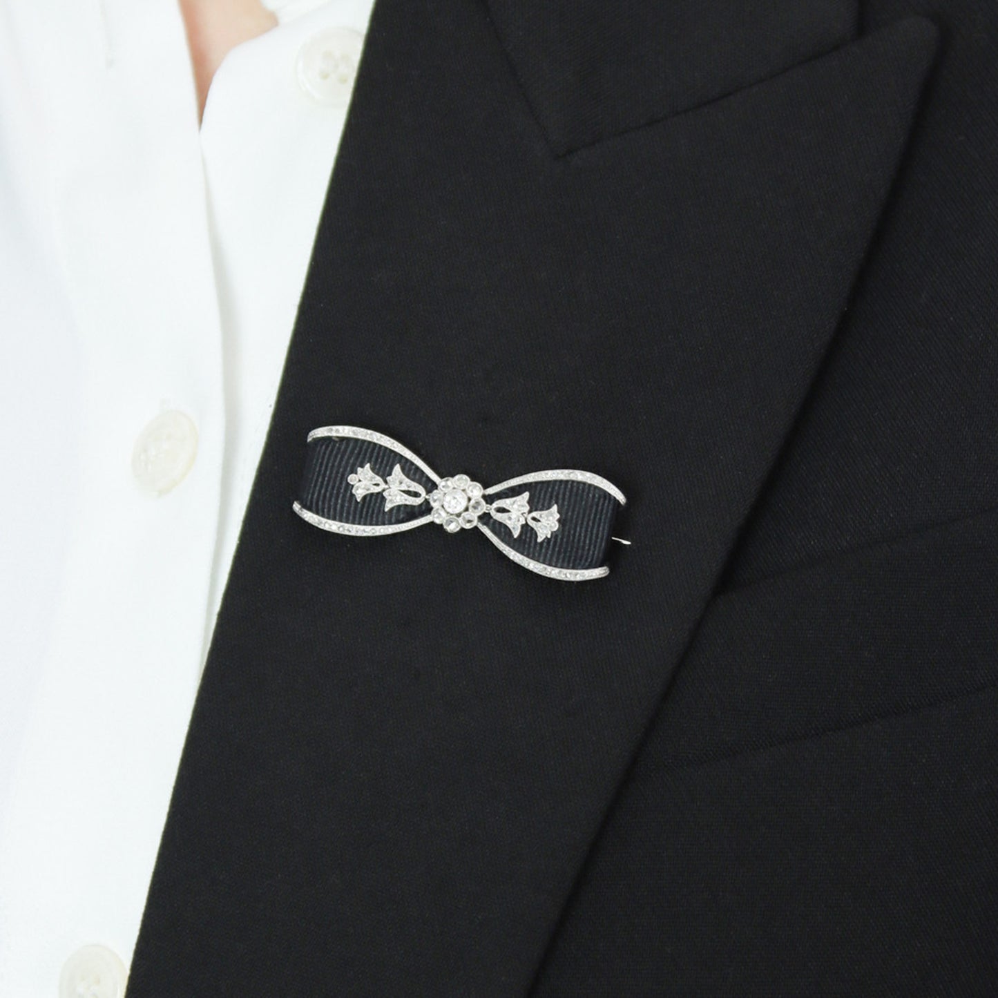 Cartier Edwardian Platinum Diamond & Ribbon Bow Brooch on lapel