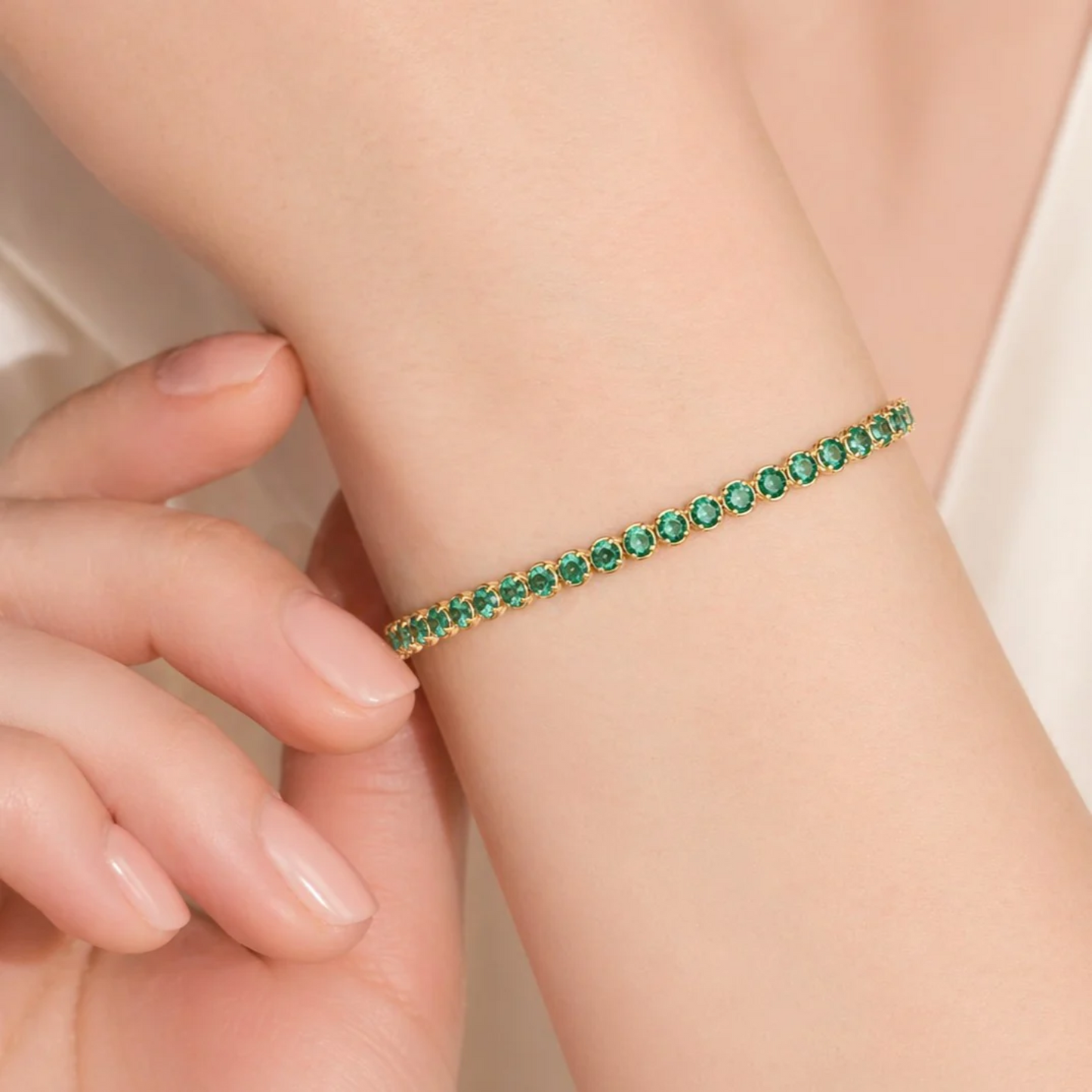 Contemporary 14KT Yellow Gold Emerald Bracelet on wrist