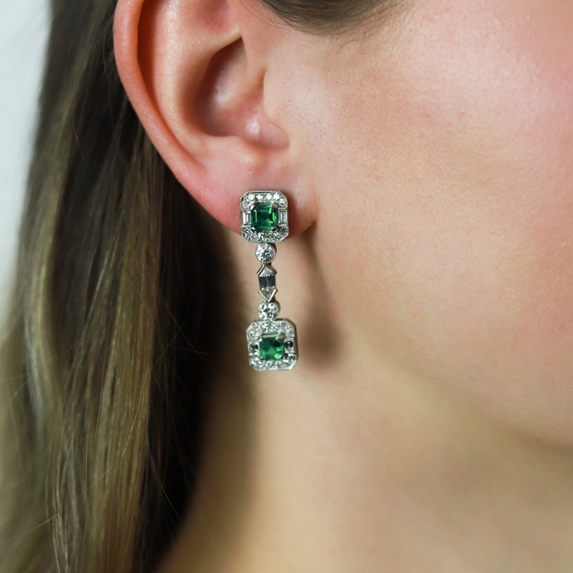 Art Deco Platinum Emerald & Diamond Earrings on ear
