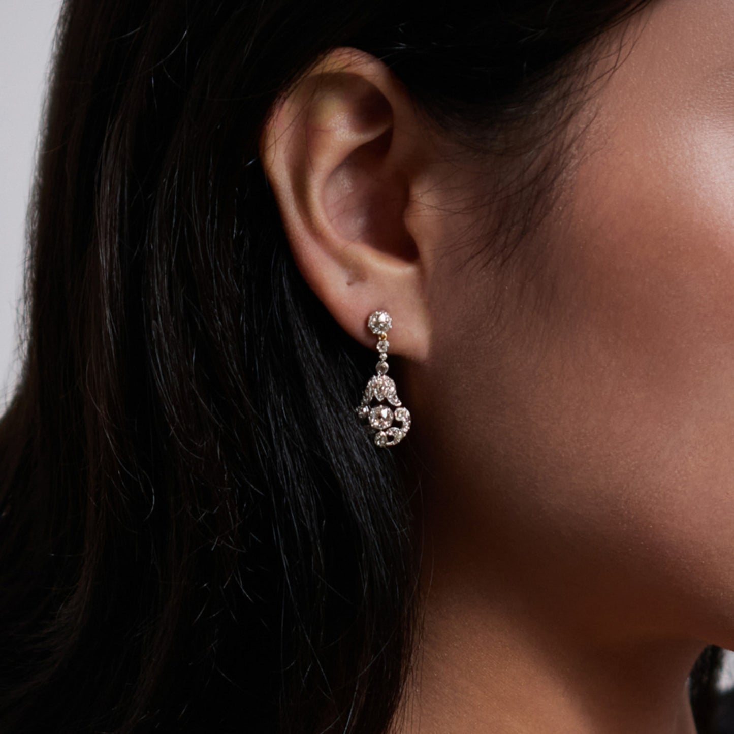 Edwardian Platinum, Silver & 18KT Yellow Gold Diamond Earrings on ear