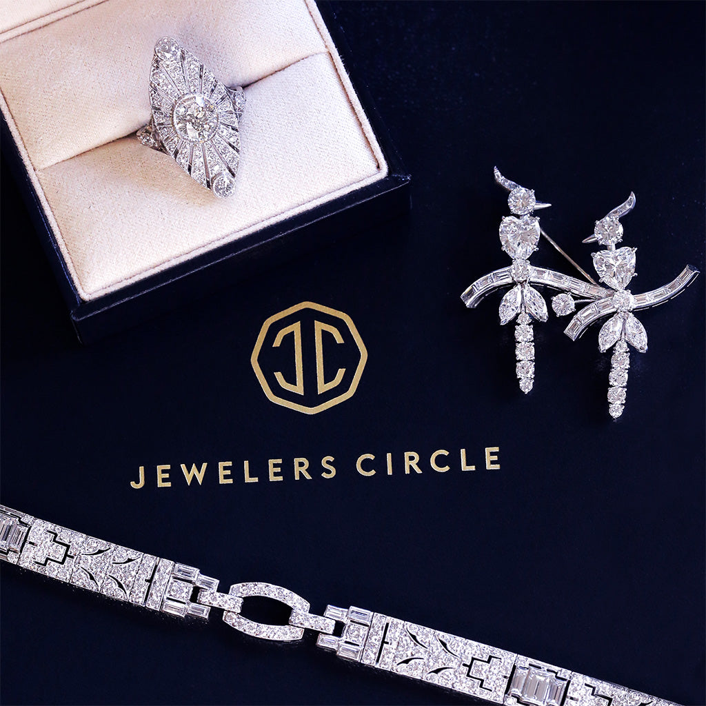 Jewelry set including ring, earrings, and bracelet on a dark background with 'Jewelers Circle' branding.