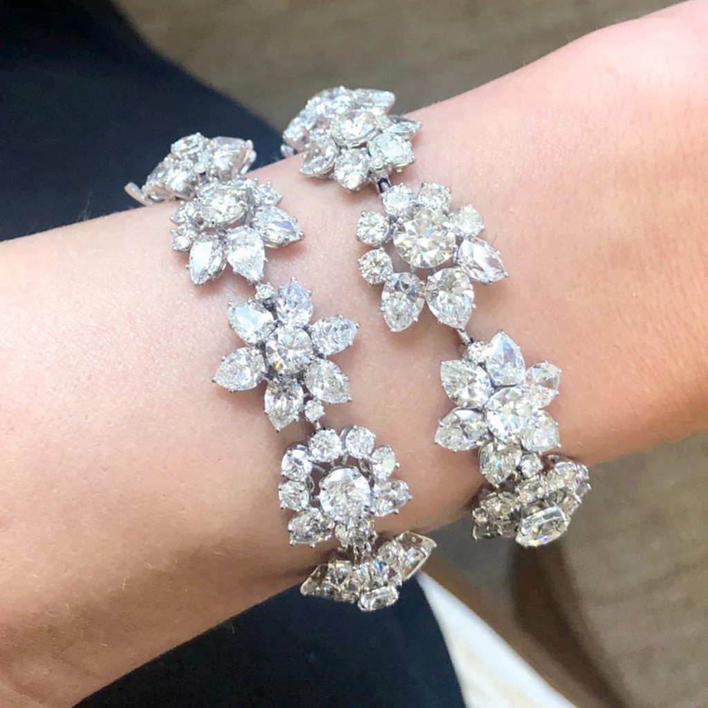 Silver diamond bracelet with floral design on a wrist