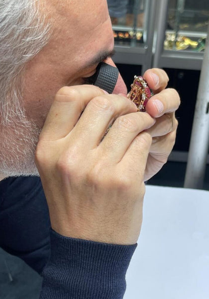 Olivier Bachet inspecting a piece of jewelry