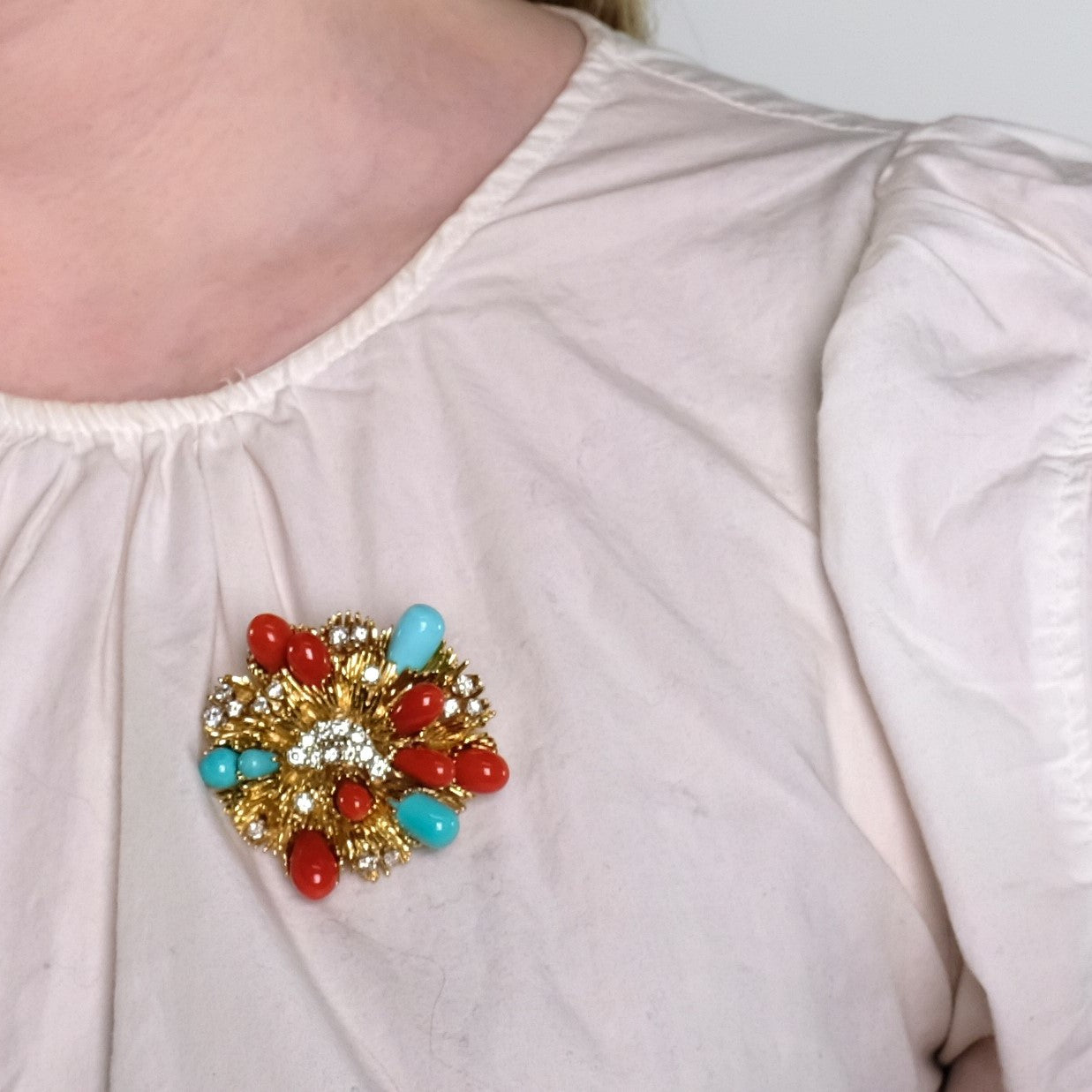 Tiffany & Co. 1960s Platinum & Yellow Gold Diamond, Coral & Turquoise Brooch worn on white blouse
