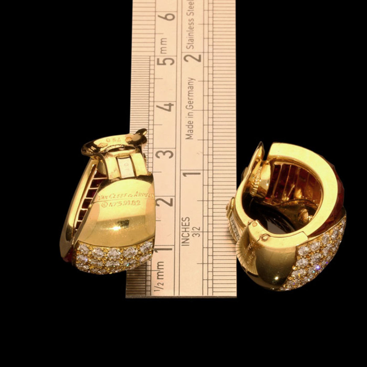 Van Cleef & Arpels 1980s 18KT Yellow Gold Ruby & Diamond Earrings next to ruler for scale