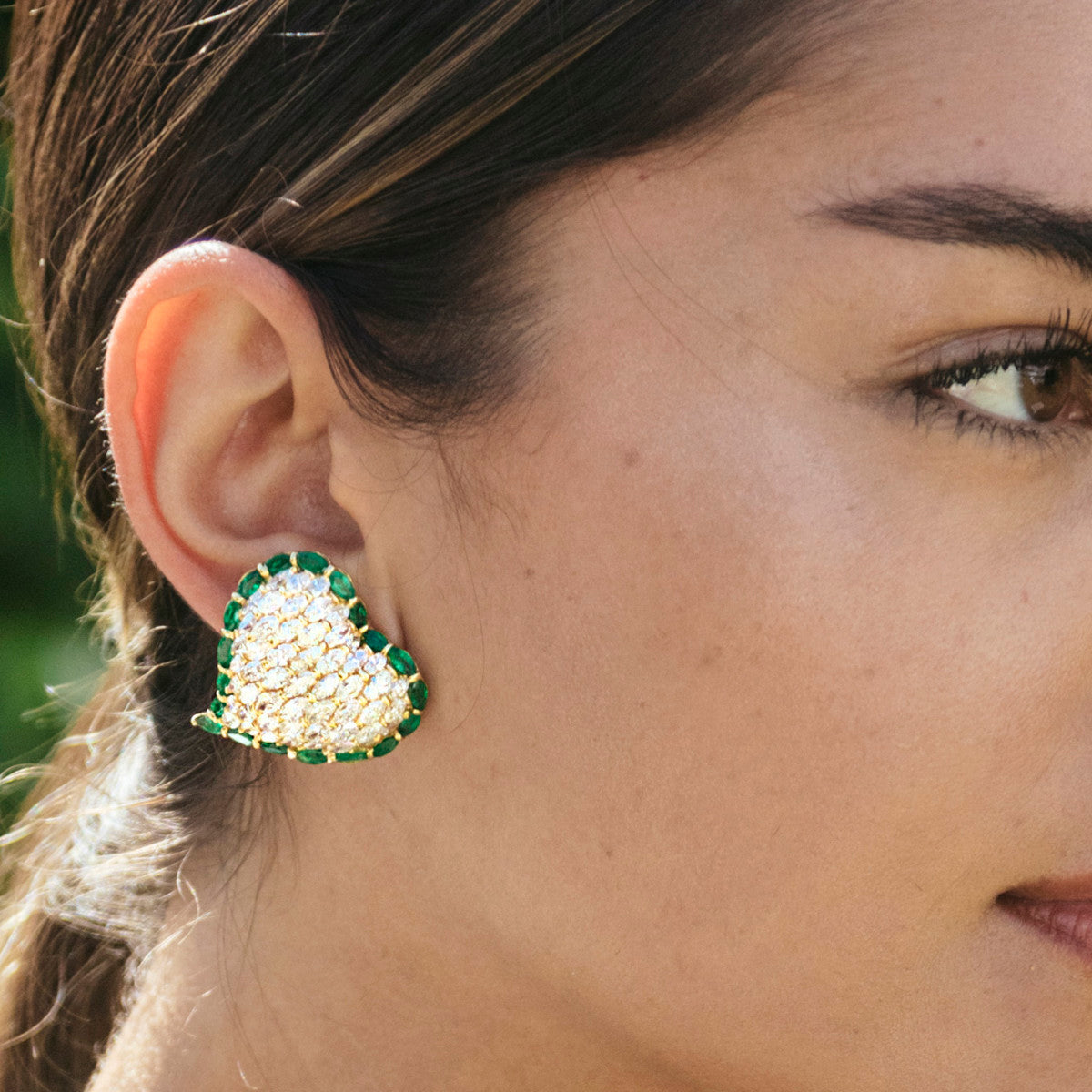 Moussaieff 1980s 18KT Yellow Gold Diamond & Emerald Heart Earrings worn on ear