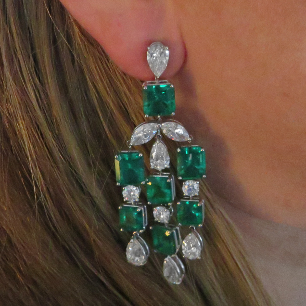 Post-1980s Platinum Emerald & Diamond Dangle Earrings worn on ear