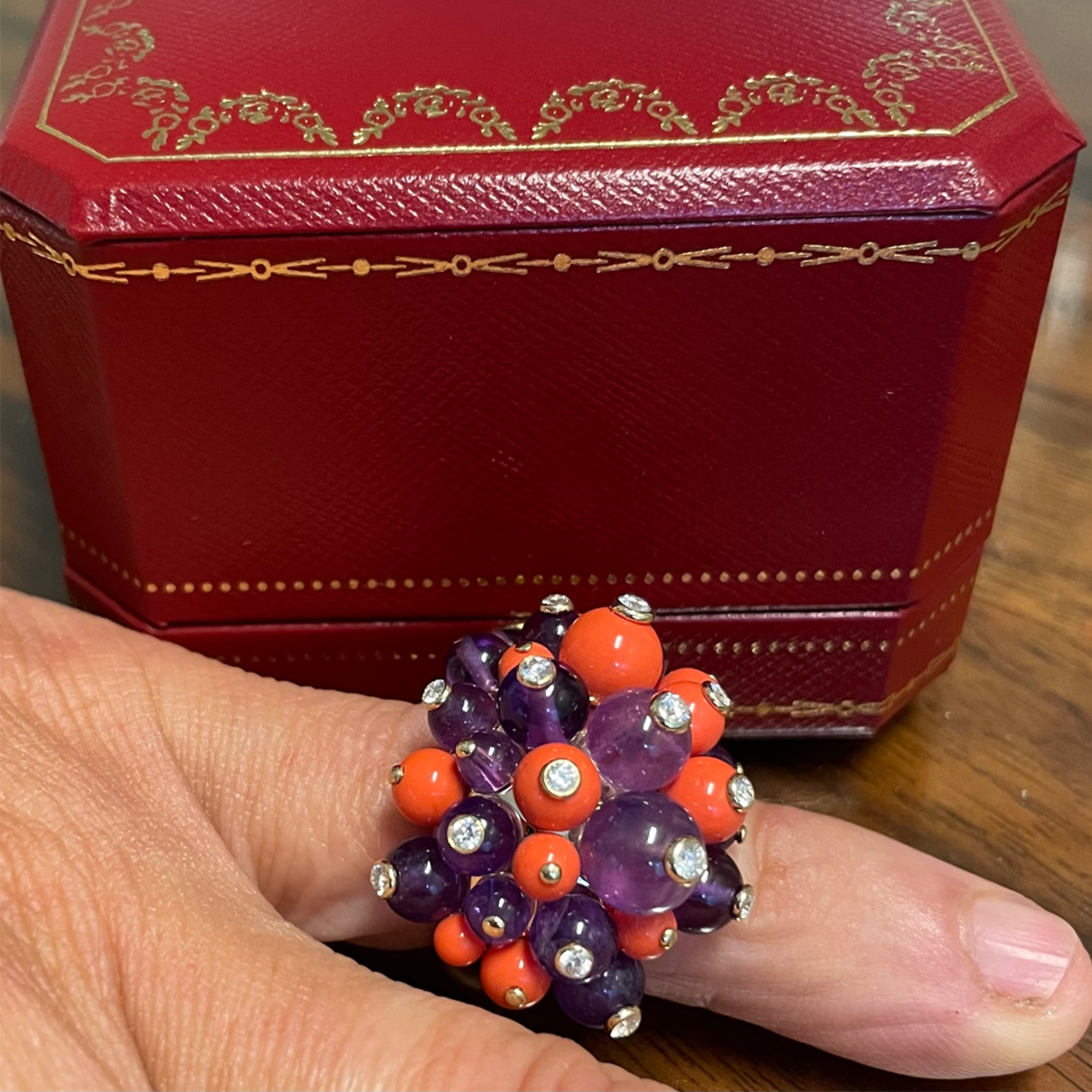 Cartier France 1970s 18KT Yellow Gold Coral, Amethyst & Diamond Pom-Pom Ring worn on finger