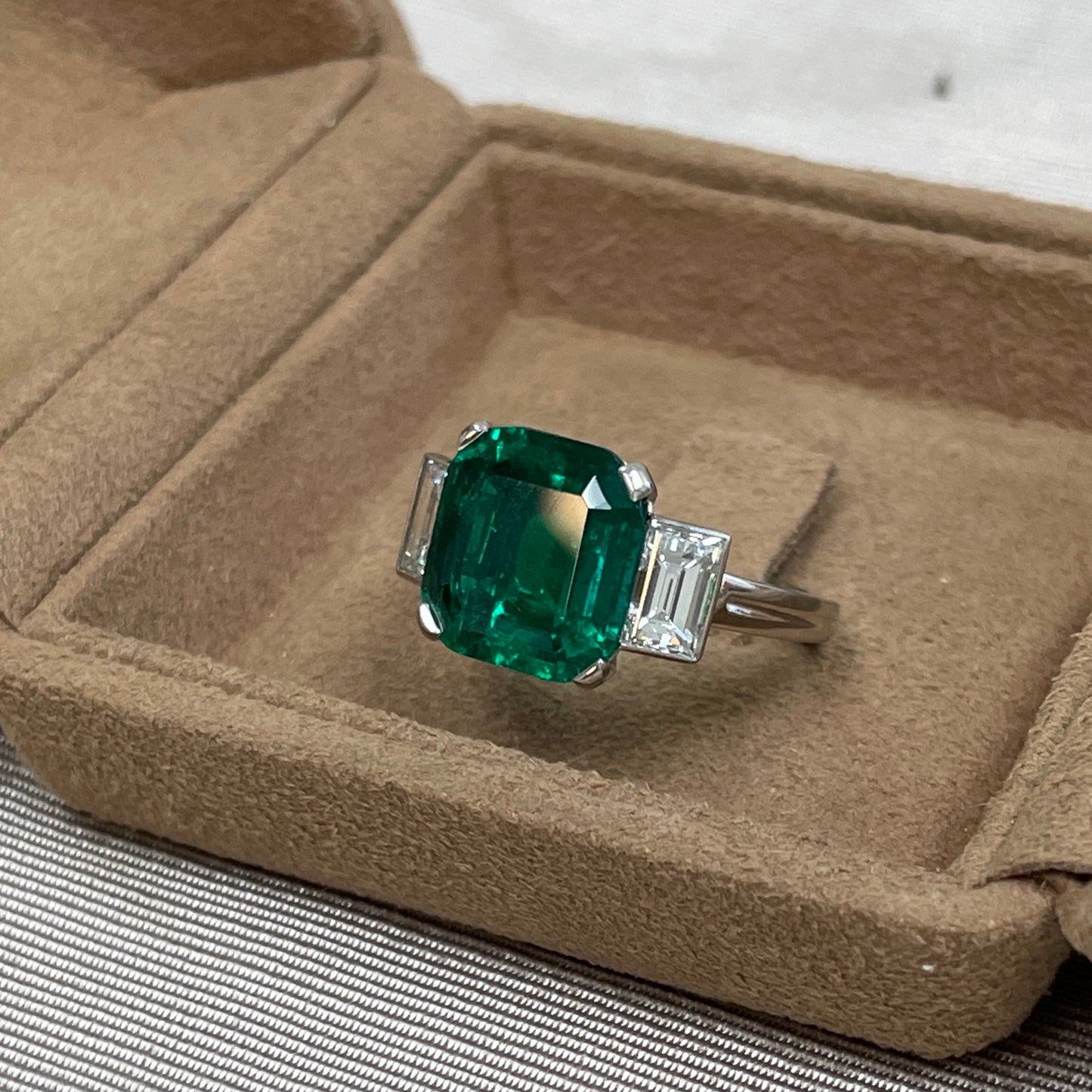 Post-1980s Platinum Colombian Emerald & Diamond Ring front view in jewelry box