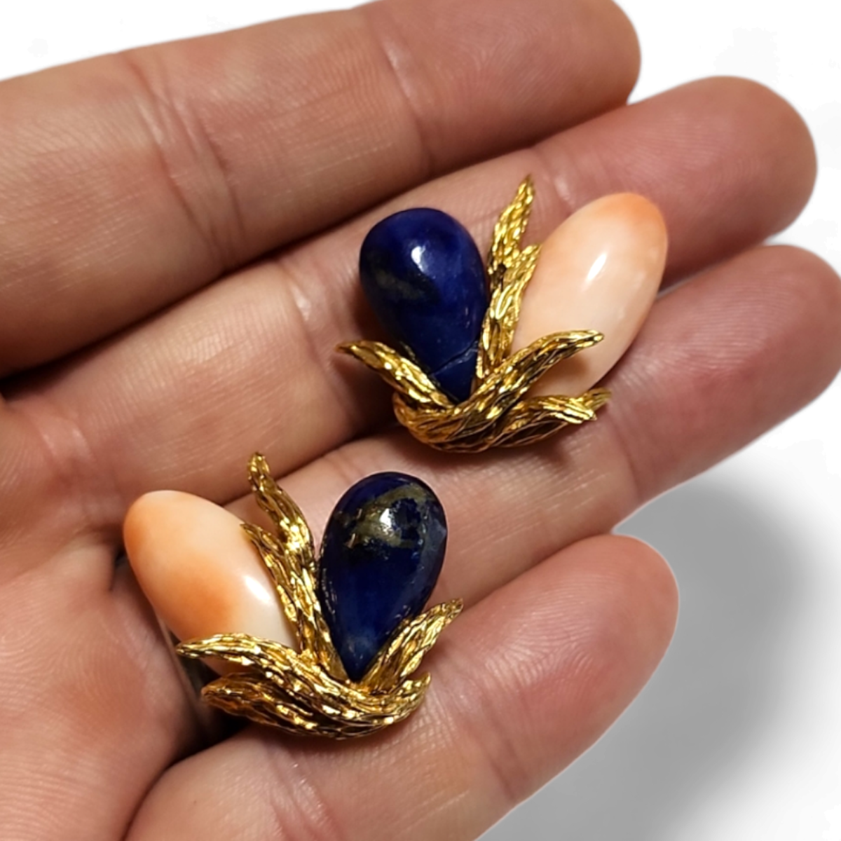 1970s 18KT Yellow Gold Angel Skin Coral & Lapis Lazuli Earrings in hand
