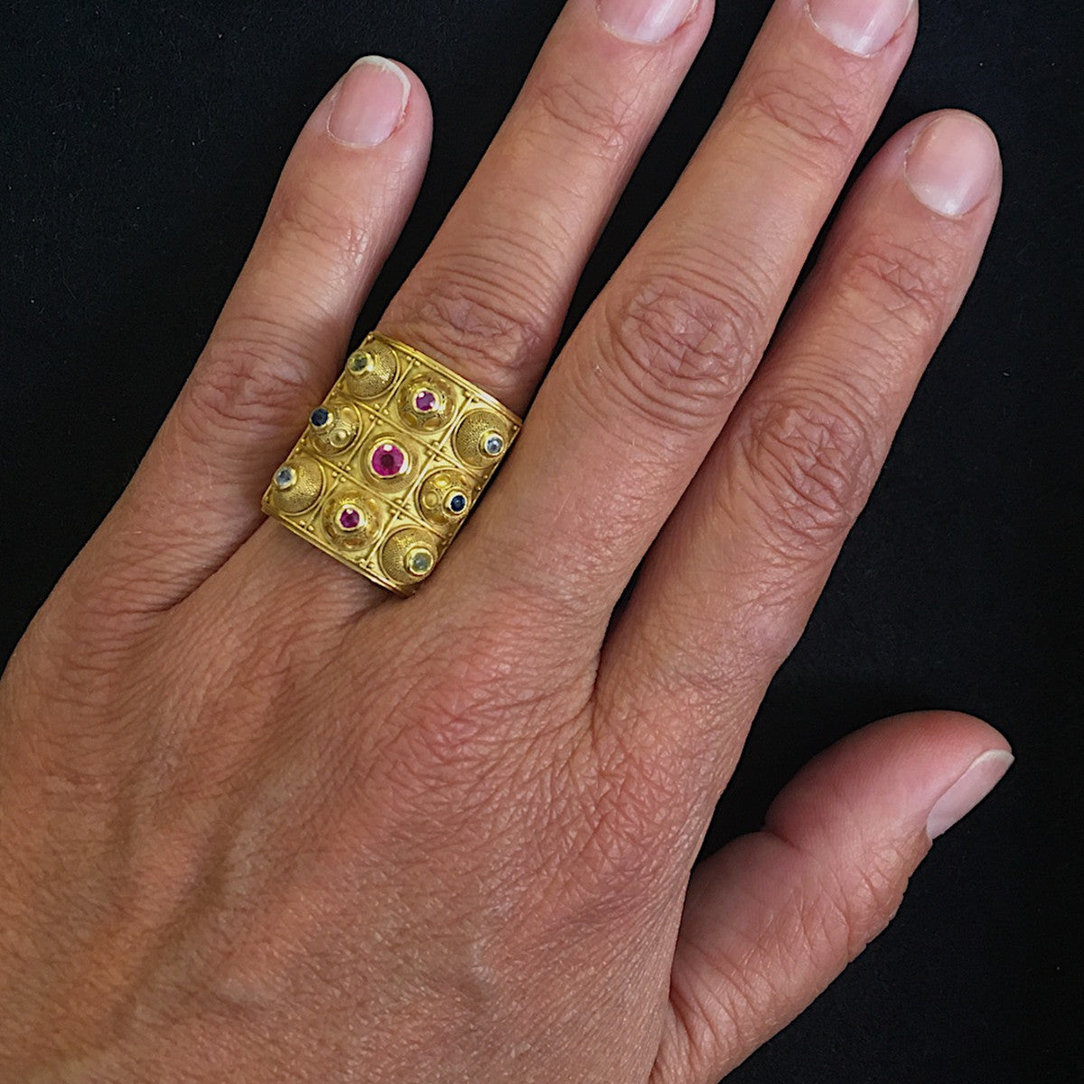 Elisabeth Treskow German 1940s 18KT Yellow Gold Ruby & Sapphire Granulation Ring on finger