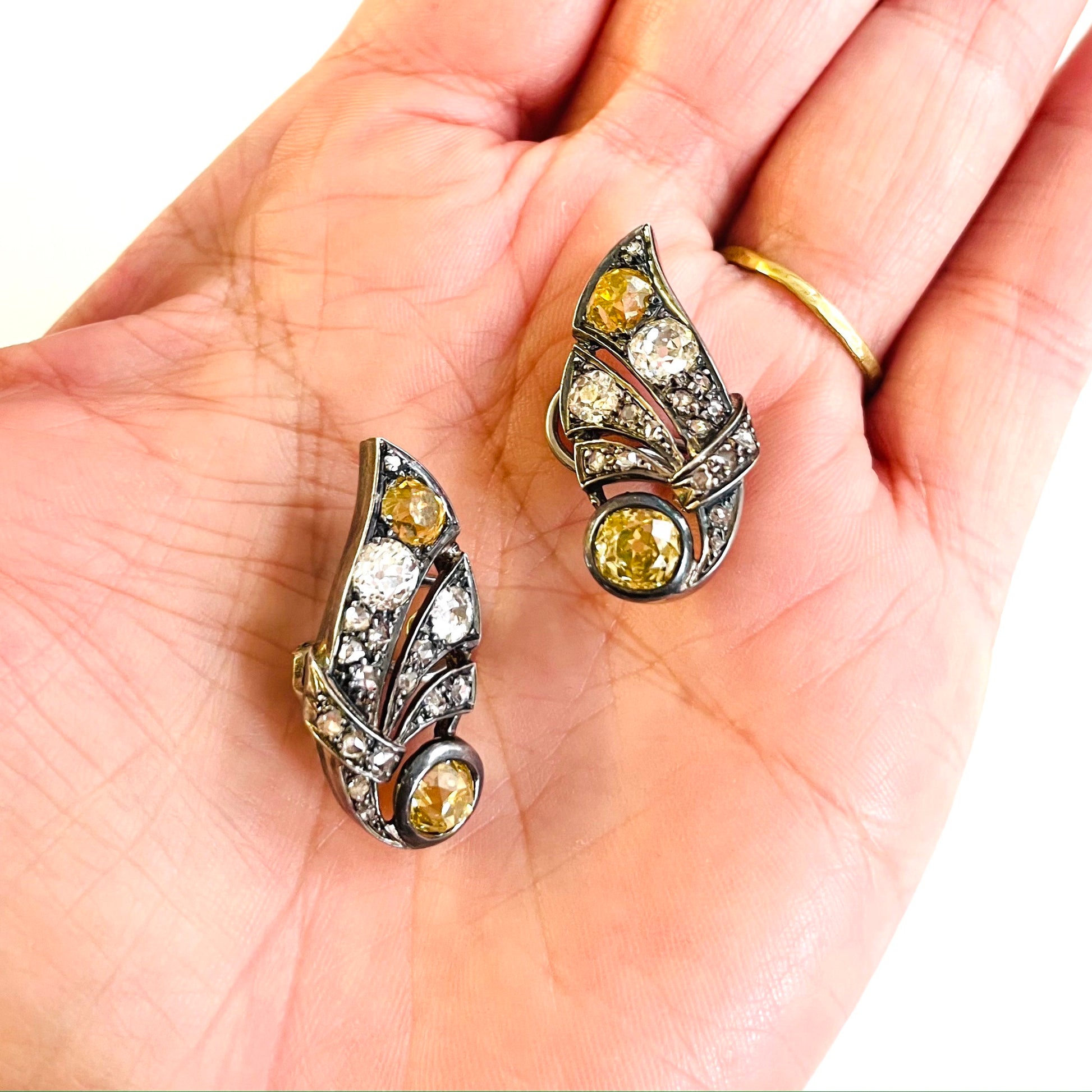 1930s Silver Yellow & White Diamond Earrings in hand