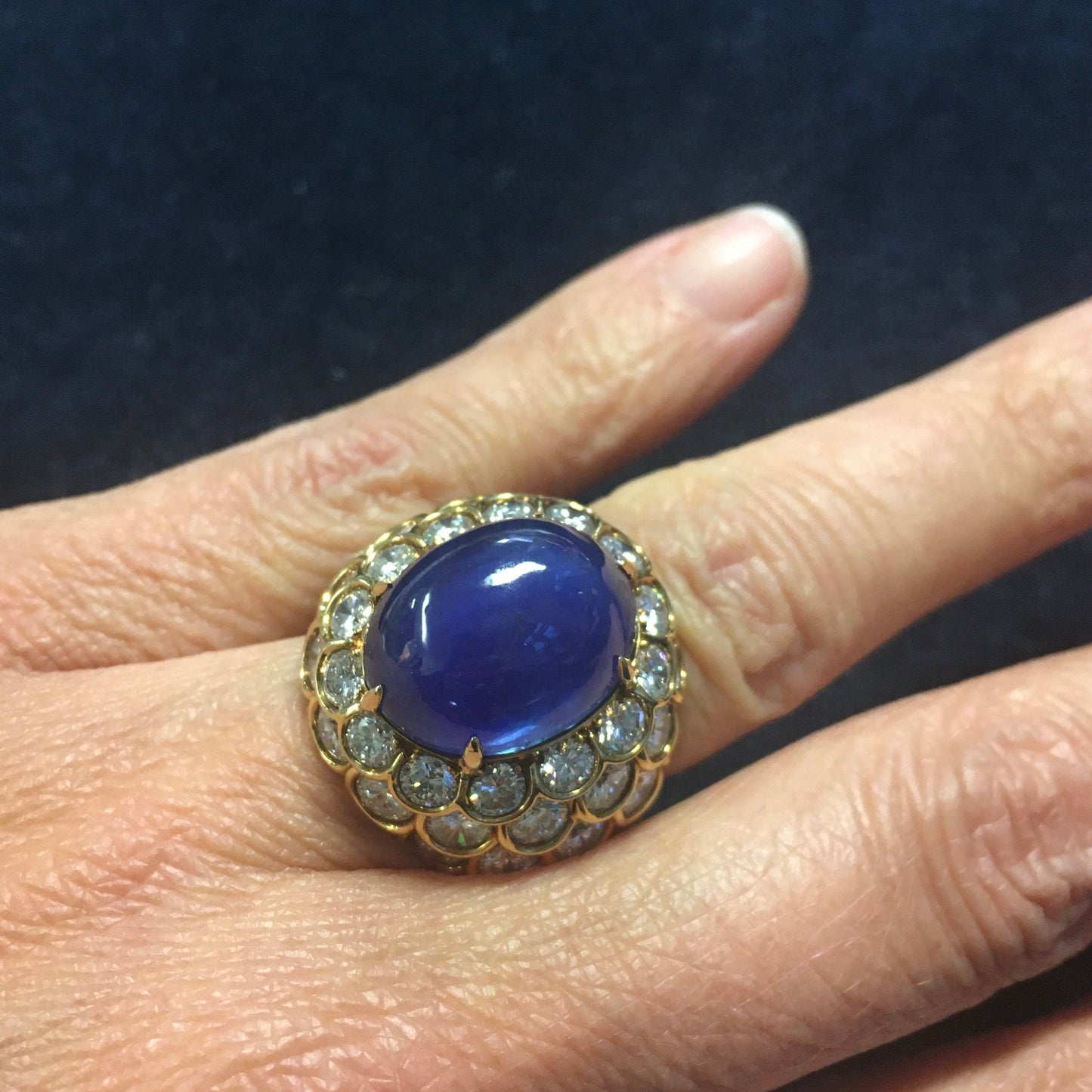 French 1960s 18KT Yellow Gold Unheated Blue Sapphire & Diamond Ring on finger