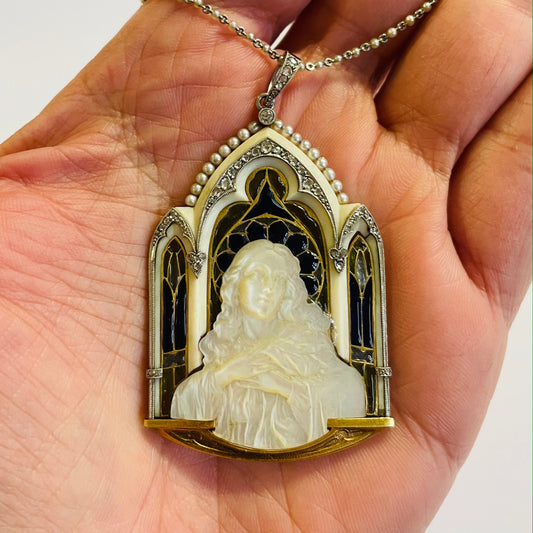 Art Nouveau 18KT Yellow Gold Enamel, Diamond, Natural Pearl & Mother of Pearl Madonna Plique-à-Jour Pendant in hand