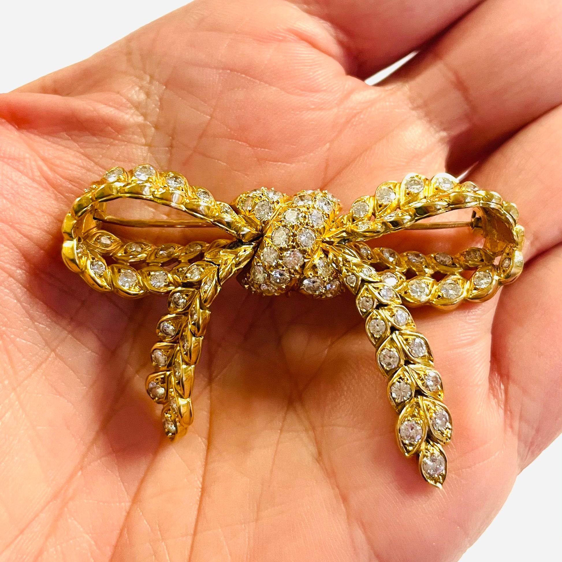 Pierre Sterlé Paris 1940s 18KT Yellow Gold Diamond Bow Brooch in hand