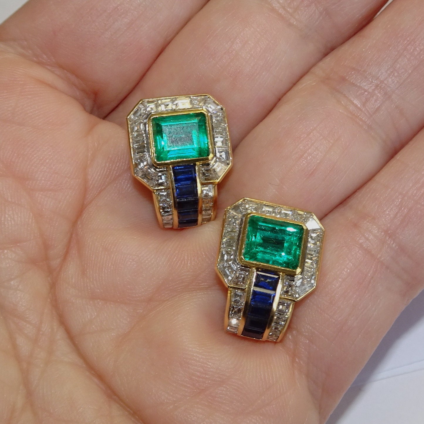 A. Hörner 1980s 18KT Yellow Gold Emerald, Diamond & Sapphire Earrings in hand