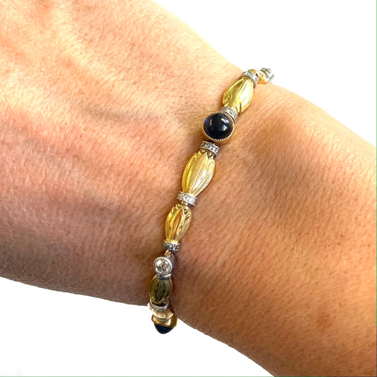 Art Nouveau Platinum & 18KT Yellow Gold Sapphire & Diamond Lotus Flower Bracelet worn on wrist