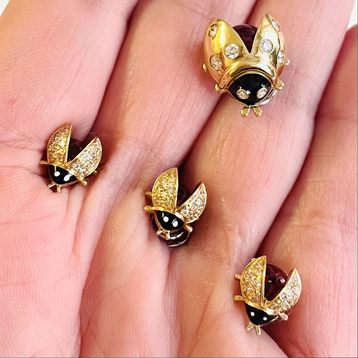 Meister Post-1980s 18KT Yellow Gold Enamel & Diamond Ladybug Brooches in hand
