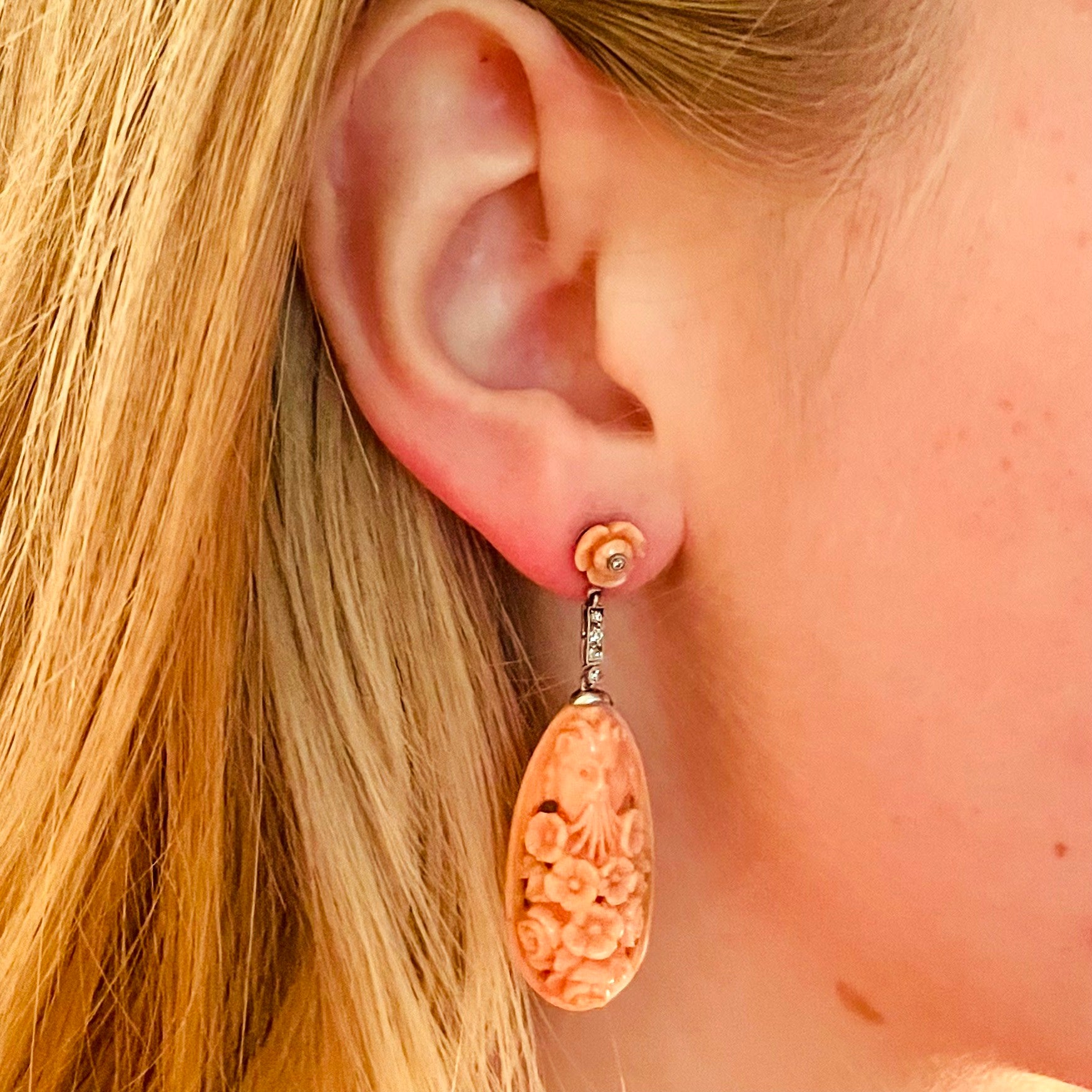 Art Deco Platinum & 18KT White Gold Carved Coral & Diamond Earrings worn on ear