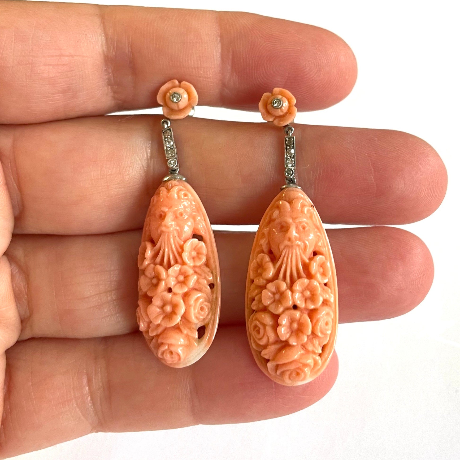Art Deco Platinum & 18KT White Gold Carved Coral & Diamond Earrings in hand
