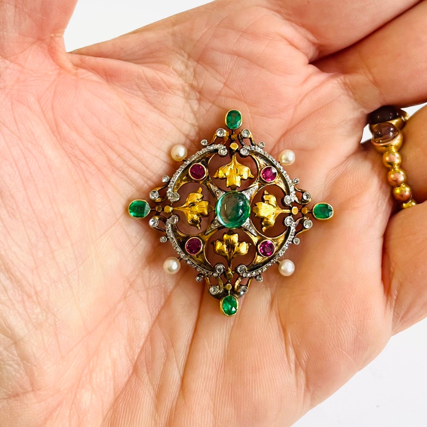 Victorian Silver & 18KT Yellow Gold Emerald, Diamond, Natural Pearl & Ruby Pendant in hand