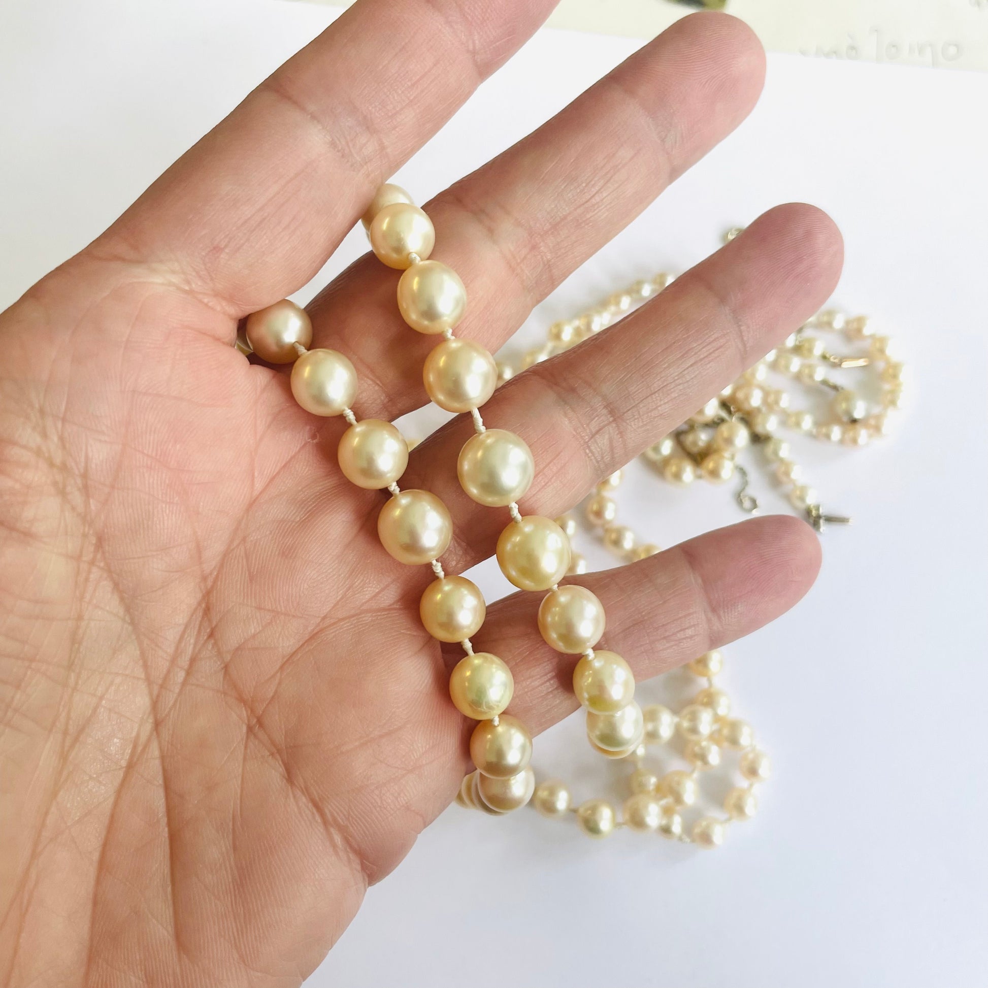1930s Platinum Natural Pearl Necklace Set in hand