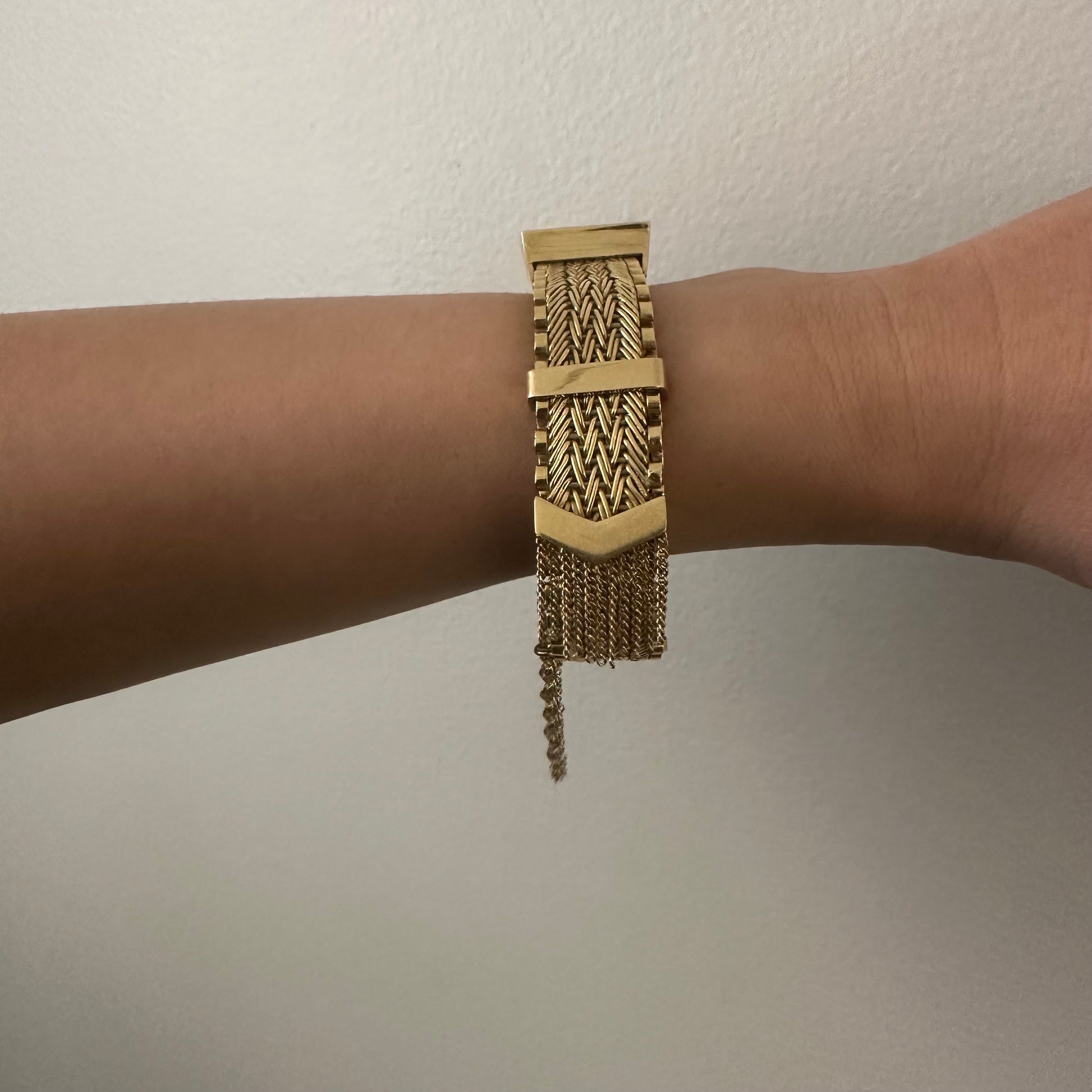 1960s 18KT Yellow Gold Tassel Bracelet worn on wrist