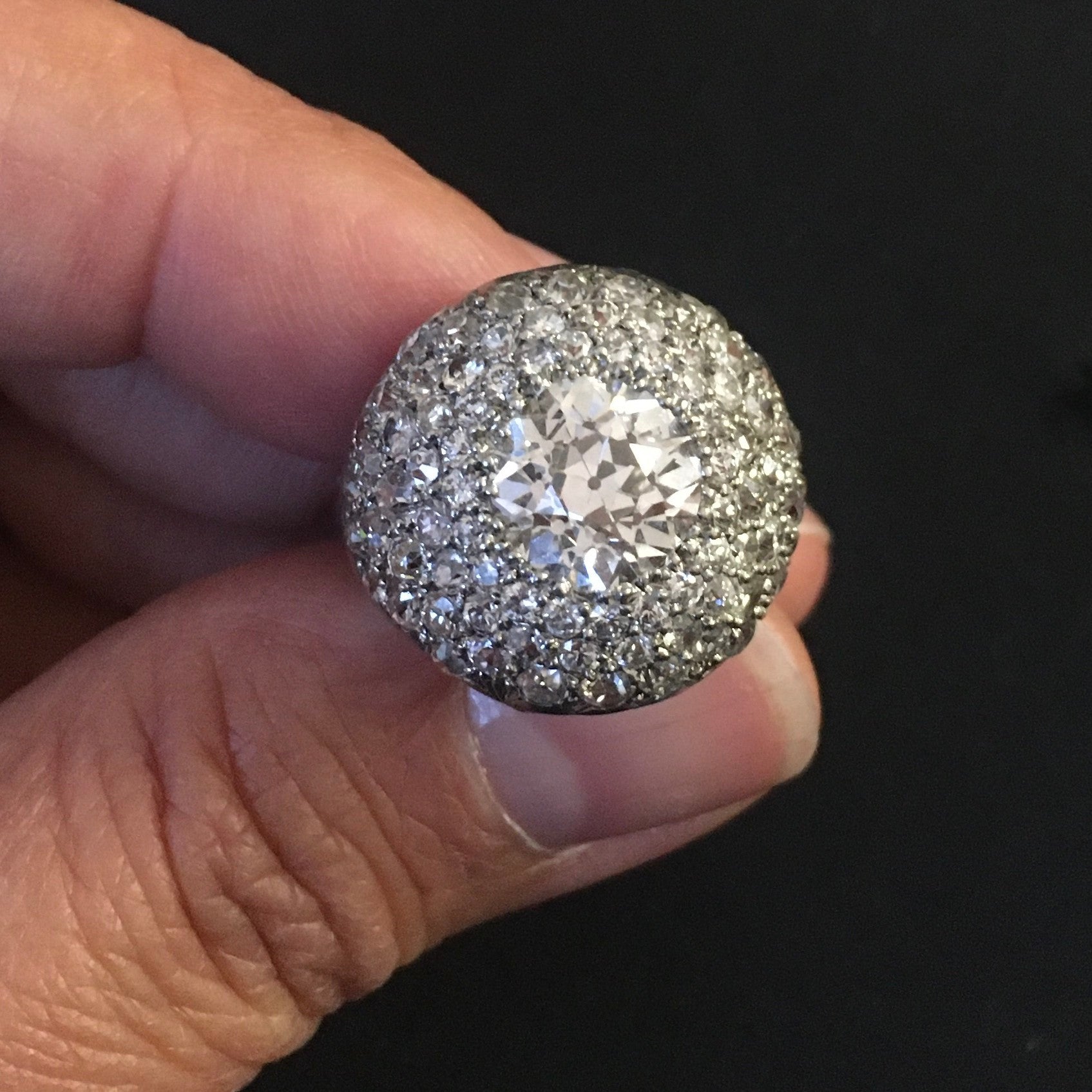 French 1930s Platinum Diamond Bombé Ring in hand