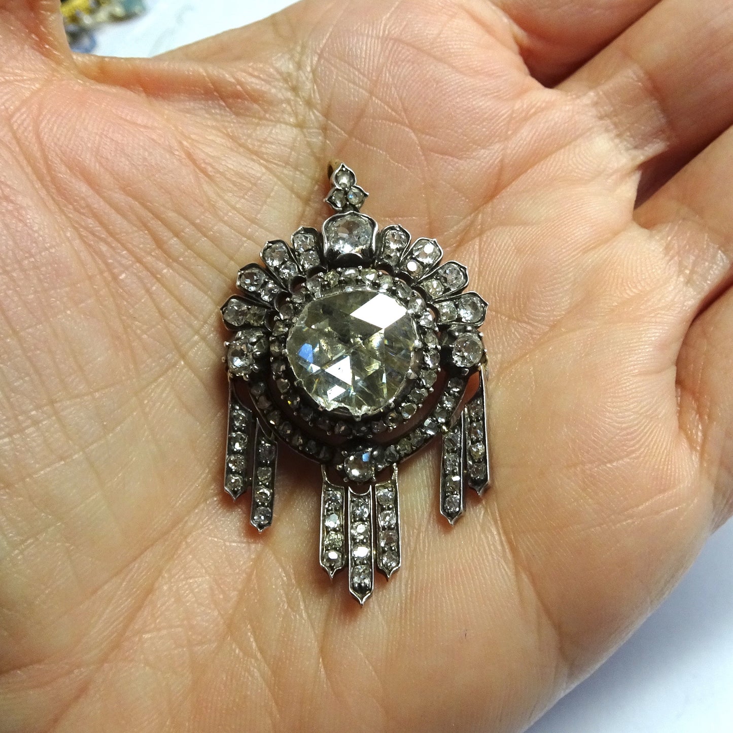 Victorian Silver & 18KT Yellow Gold Diamond Pendant in hand
