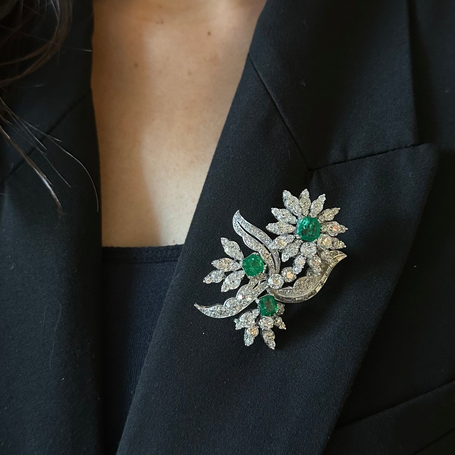 1960s Platinum Diamond & Emerald Flower Brooch worn on blazer
