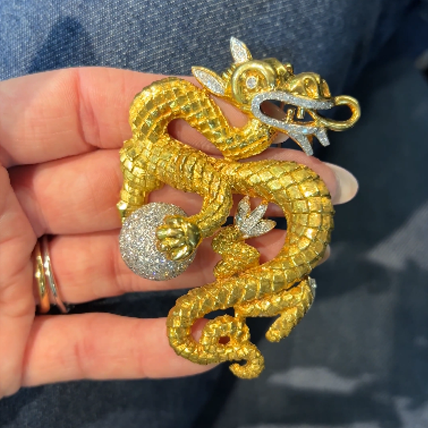 1960s 18KT Yellow Gold Diamond Dragon Brooch in hand